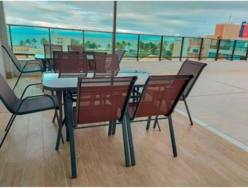 a table and chairs on top of a roof at Flat com piscina a 200m da praia in Cabedelo