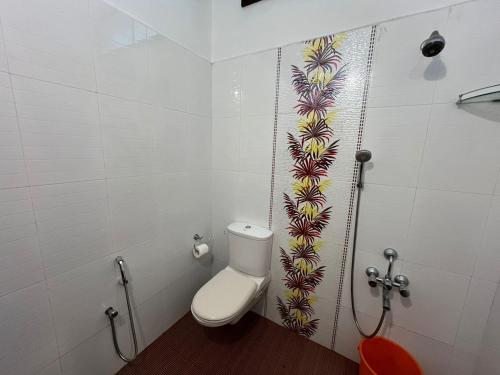 a bathroom with a toilet and a shower at Marari Beach Villas in Mararikulam