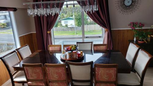 a dining room with a table and chairs and a window at Bed and Breakfast Happy Home Taupo Accommodation in Taupo