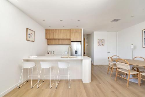 a kitchen and dining room with a table and chairs at Blanca Beach House 2 Vincentia in Vincentia
