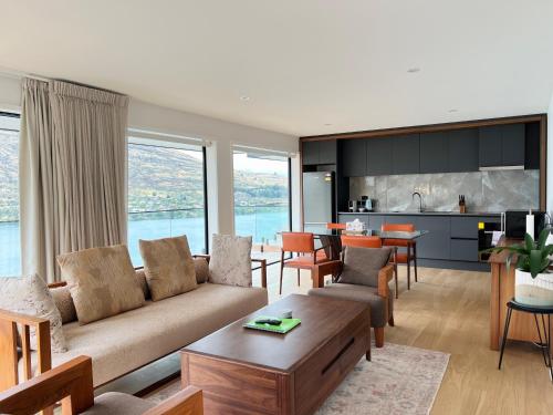 a living room with a couch and a table at Stunning Lakeview Holiday House Queenstown in Frankton Wharf