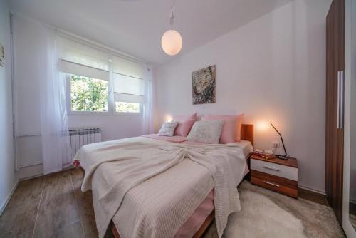 a bedroom with a large bed and a window at Apartments with WiFi Varazdin, Zagorje - 22171 in Varaždin