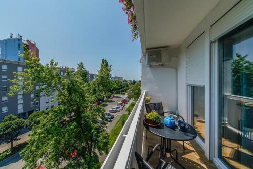 an apartment balcony with a table and chairs and a street at Apartments with WiFi Varazdin, Zagorje - 22171 in Varaždin