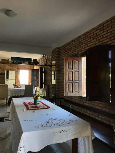 um quarto com uma mesa com uma toalha de mesa branca em Vila Janaína em Canoa Quebrada