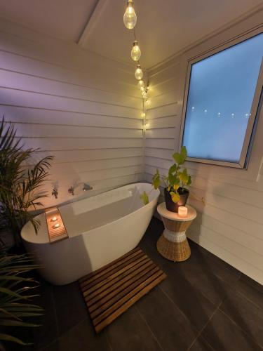 a bathroom with a bath tub and a window at Luxury private guest suite in the Blue Mountains in Springwood