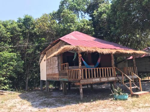 a small hut with a red roof and a porch at Naks Shack in Koh Ta kiev Island