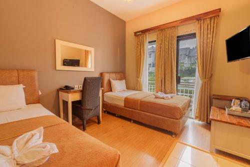 Ένα ή περισσότερα κρεβάτια σε δωμάτιο στο Hotel Griya Katarina