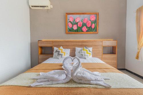 Ένα ή περισσότερα κρεβάτια σε δωμάτιο στο Hotel Griya Katarina