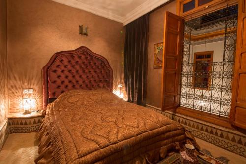 a bedroom with a large bed in a room at Riad Scalia Traditional Guesthouse Fes Morocco in Fès