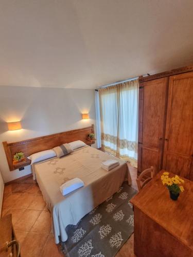 a hotel room with two beds and a table at Domos de Ammentos in Tortolì