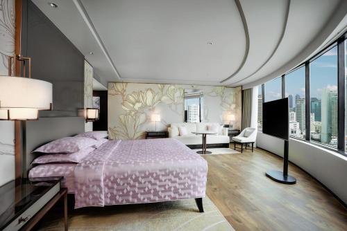 a bedroom with a pink bed and a large window at JW Marriott Hotel Bangkok in Bangkok