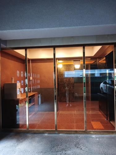 a glass door of a building with a car in it at BT Hotel in Busan