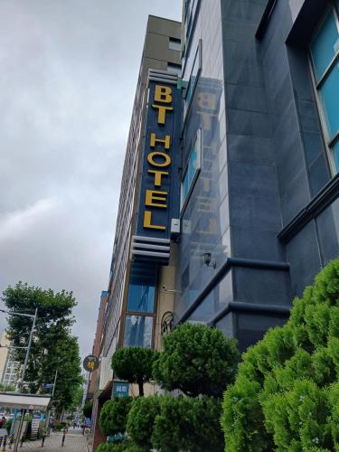 a hotel sign on the side of a building at BT Hotel in Busan