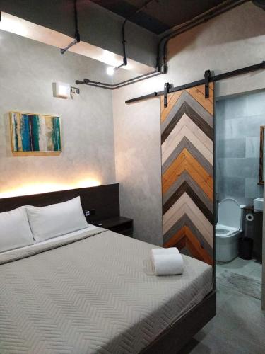 a bedroom with a bed and a bathroom at Kasa Boutique Hotel in Cebu City