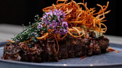 a piece of meat with flowers on top of it at Kimpton Hotel Palomar Los Angeles Beverly Hills by IHG in Los Angeles