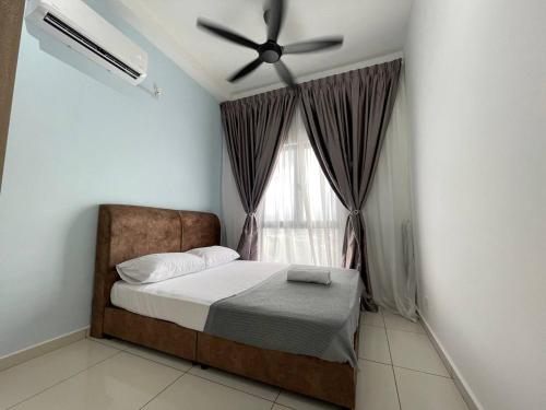 a bedroom with a bed with a ceiling fan and a window at Seri Ipoh - Horizon Apartment in Ipoh