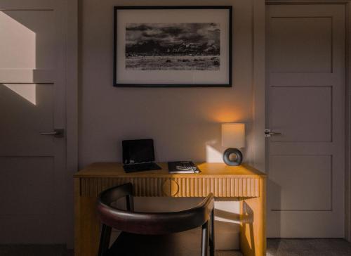 a desk with a chair and a laptop on it at Aspects Big Sky in Big Sky