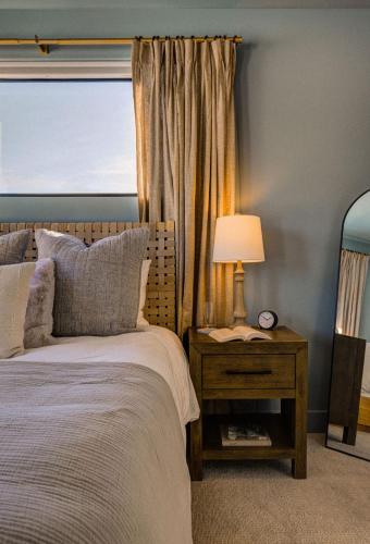 a bedroom with a bed and a table with a lamp at Aspects Big Sky in Big Sky