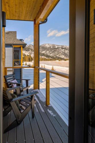 a porch with a bench and a view of the mountains at Aspects Big Sky in Big Sky
