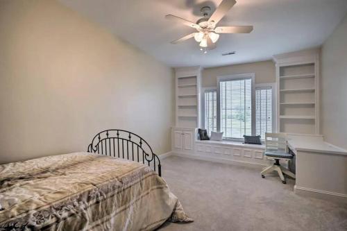 a bedroom with a bed and a desk and a ceiling fan at Manor on the 7th in Gettysburg