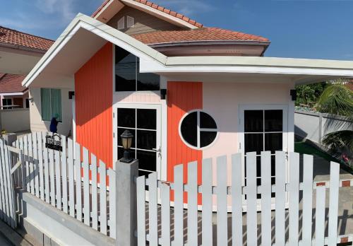 a small house with a white fence at Family POOL VILLA CHAAM in Cha Am