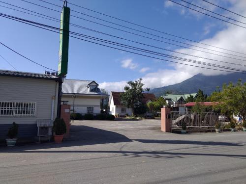an empty street with a mountain in the background at Pleasure Leisure Villa in Guanshan