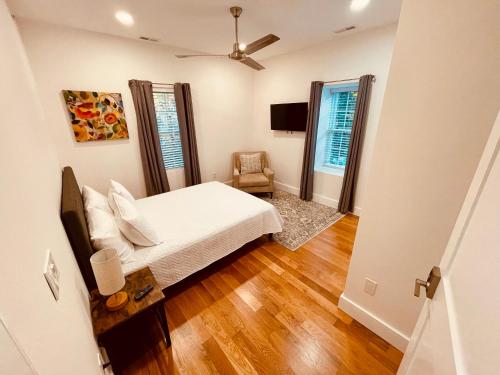 a bedroom with a bed and a chair in it at Perrin Place Unit 3 in Boston