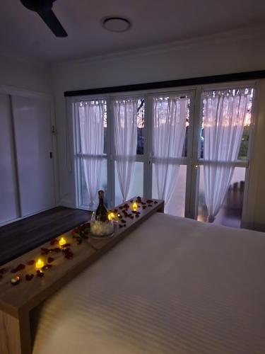 a room with a table with candles and a window at Luxury private guest suite in the Blue Mountains in Springwood