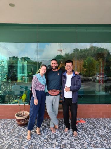 a group of three people standing in front of a building at Tekoma Resort Cameron Highlands in Tanah Rata