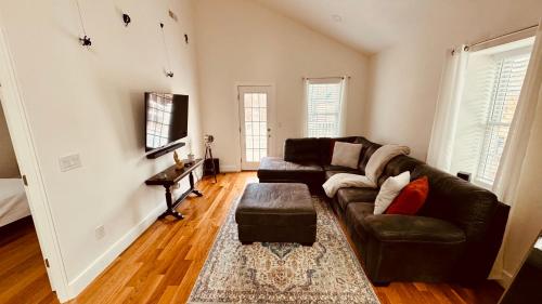 a living room with a couch and a table at Perrin Place Unit 3 in Boston
