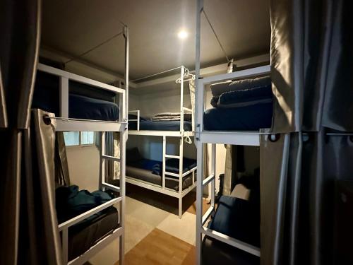 a room with several bunk beds in a room at Sweed Dee Seaview Hostel in Phi Phi Islands
