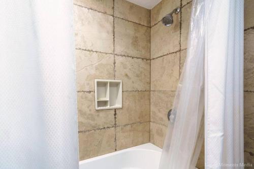 y baño con ducha con cortina blanca. en Spacious Beachfront — Sleeps 6 — Ocean Views en Kihei