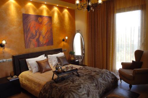 a bedroom with a large bed and a chair at Olympic Fashion Hotels in Athens