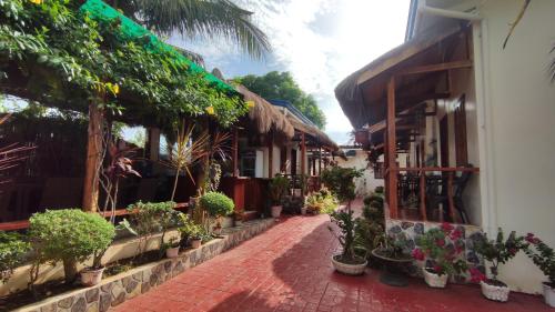 a street with potted plants on the side of a building at Glorias Panglao Inn 1 in Panglao