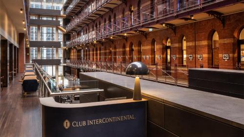 a large library with a ball on top of a table at InterContinental Melbourne The Rialto, an IHG Hotel in Melbourne