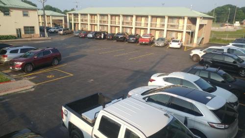 a parking lot with cars parked in front of a building at Riviera Inn And Suites 1000 Islands in Gananoque