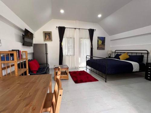 a bedroom with a bed and a television in it at Charming Villa Suite with Balcony near Beach in Patong Beach