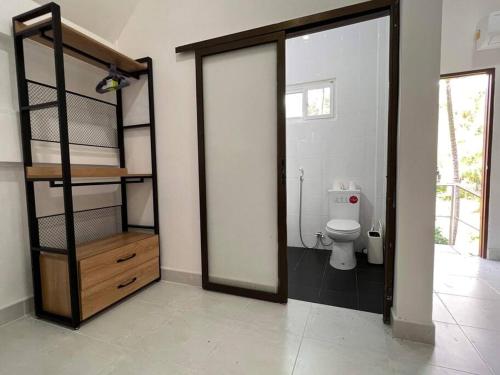 a bathroom with a toilet and a room with a doorway at Charming Villa Suite with Balcony near Beach in Patong Beach