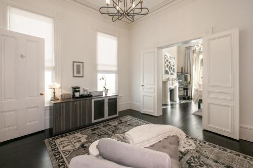 a white living room with a couch and a chandelier at Pacific Heights Grand Elegant Studio in San Francisco