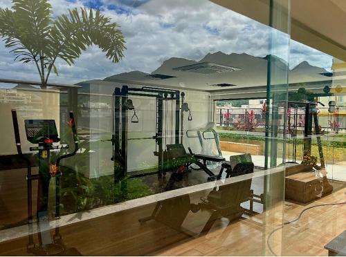 a room with a glass wall with a room with a treadmill at Rio De Janeiro Freguesia Jacarepaguá Lotf in Rio de Janeiro