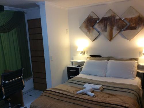 A bed or beds in a room at Pousada Dos Comissarios