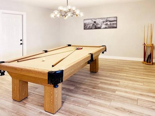a wooden pool table in a room with ahibition at South Scottsdale remodeled beauty in Scottsdale