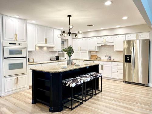 a large kitchen with a black island in the middle at South Scottsdale remodeled beauty in Scottsdale