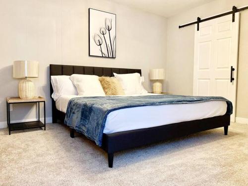 a bedroom with a large bed with two lamps on it at South Scottsdale remodeled beauty in Scottsdale