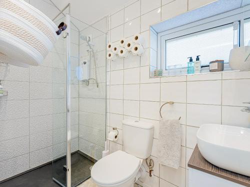 a bathroom with a toilet and a sink at The Hideaway in Great Meols