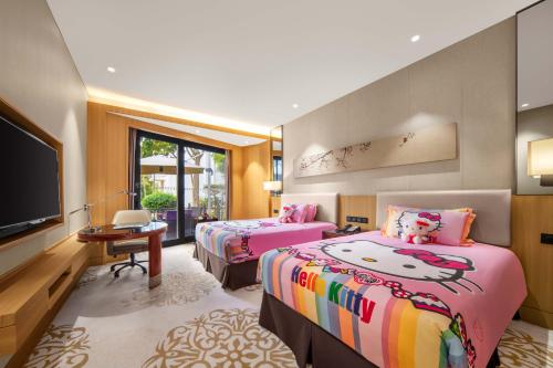a bedroom with two beds and a flat screen tv at Xiamen C&D Hotel-Free Welcome Snacks-Oasis Garden in Xiamen