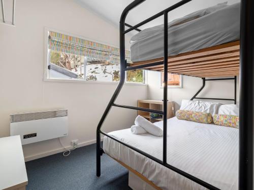 a bedroom with two bunk beds and a window at Tombarra 4B in Thredbo