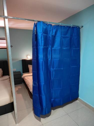 a blue curtain in a bedroom with a bunk bed at Tekoma Resort Cameron Highlands in Tanah Rata