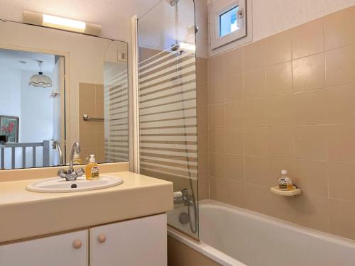 une salle de bain avec un lavabo, une douche et une baignoire dans l'établissement Duplex avec piscine, 3 pièces cabine, 6 couchages, terrasses et parking proche plage - Le Lavandou - FR-1-251-536, au Lavandou