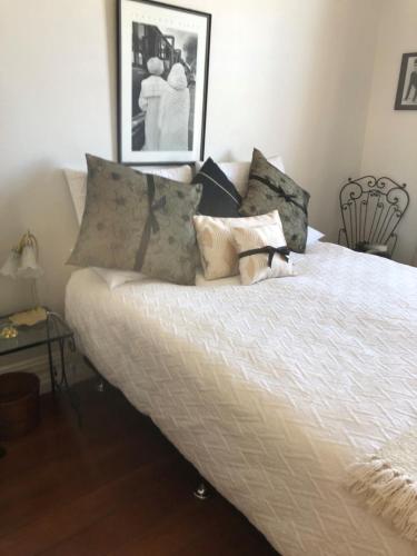 a white bed with pillows on it in a room at Ponsonby Boutique Villa with Private Gym in Auckland